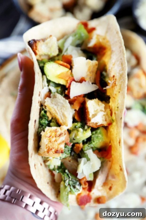 Hand holding a taco with salad