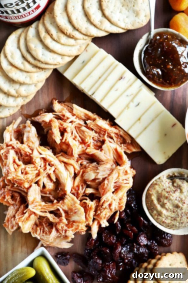 A close-up of Head Country Bar-B-Q pulled chicken, glistening with sauce.