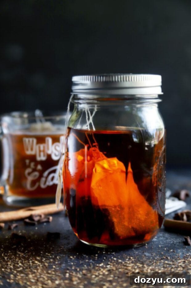 Infusing bourbon with chai tea bags in a mason jar, illustrating the infusion process