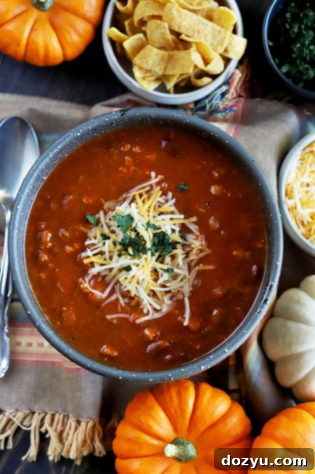 A bowl of Slow Cooker Pumpkin Turkey Chili, rich and hearty for a fall meal.