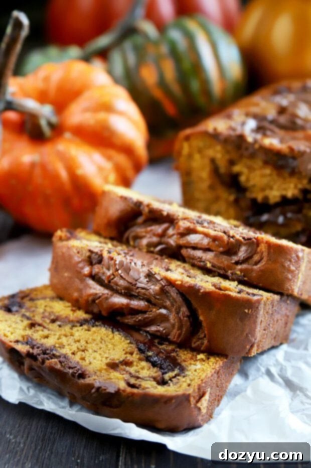 A slice of spiced pumpkin banana bread with a swirl of Nutella, a perfect fall baked treat.