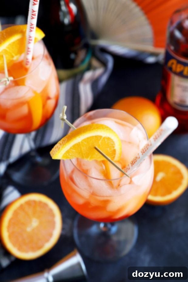 A beautifully garnished Italian Aperol Spritz cocktail with an orange slice, resting on a table, ready to be enjoyed as a refreshing drink.