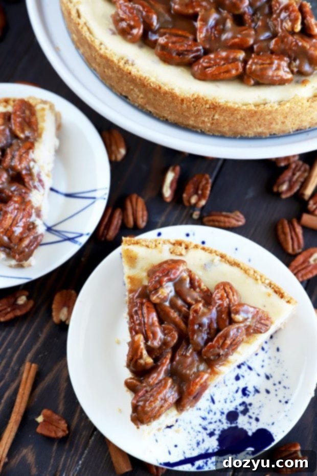 Close-up of three slices of pecan pie cheesecake with a rich pecan topping.