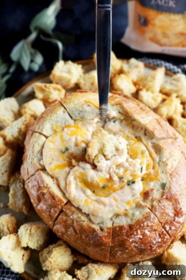 Holiday bread bowl dip with spoon in it