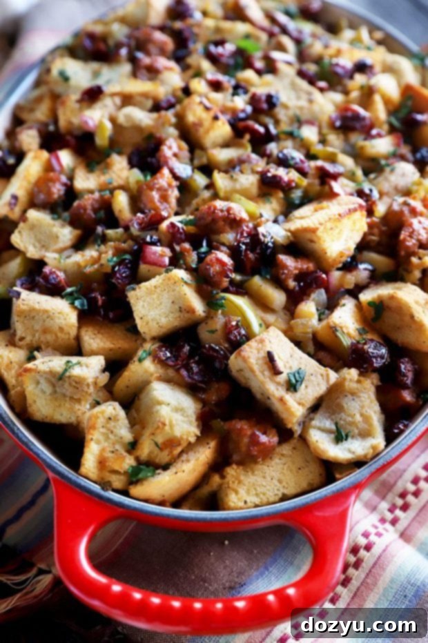 Harvest Apple, Caramelized Onion, and Sausage Stuffing 4 Stuffing served in an oval baking dish, ready for Thanksgiving dinner