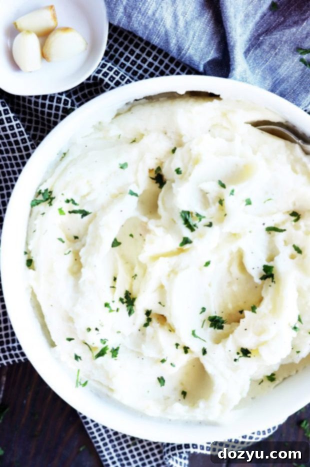 Instant Pot Mashed Potatoes with Roasted Garlic and Parmesan, served in a rustic bowl.