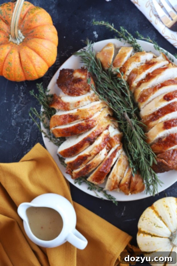 Overhead photo of thanksgiving turkey breast garnished with fresh herbs.