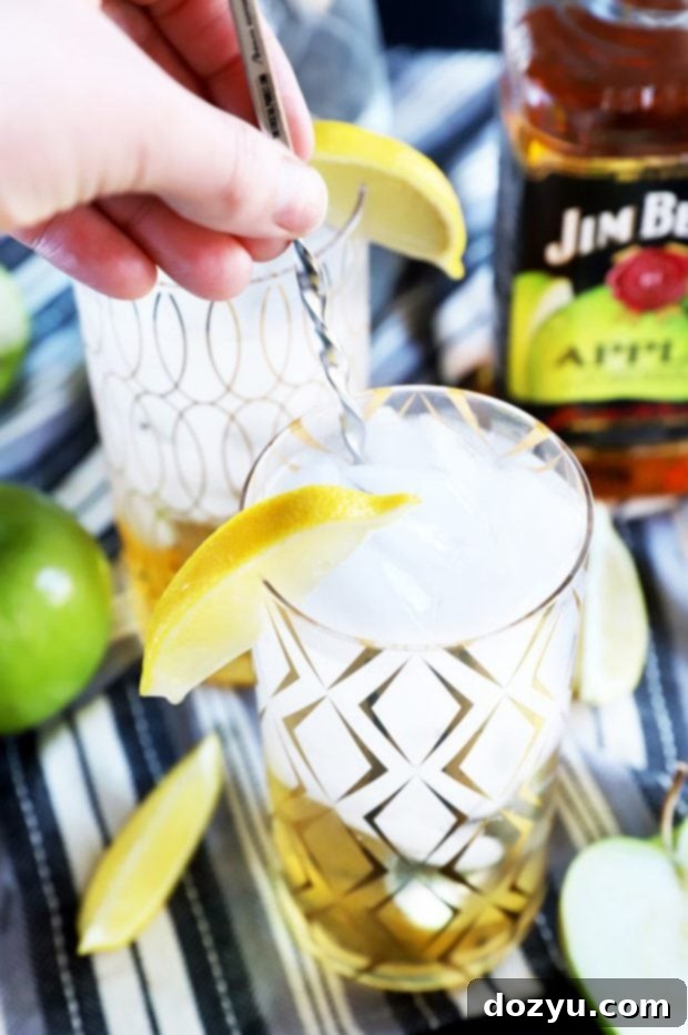 Sparkling Jim Beam Apple Soda 6 Hand stirring a cocktail in a glass photo