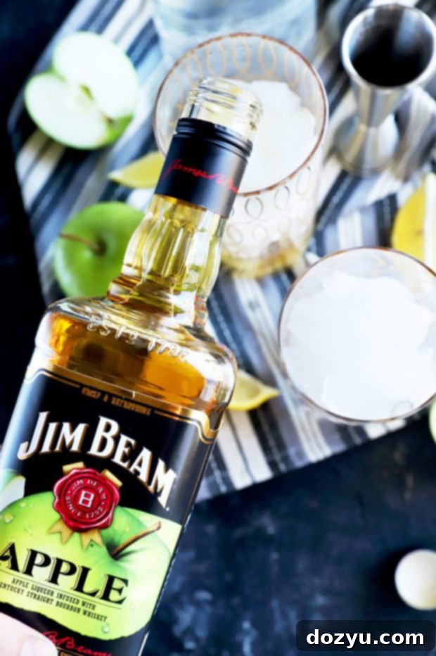 Sparkling Jim Beam Apple Soda 8 Pouring Jim Beam Apple into a cocktail glass
