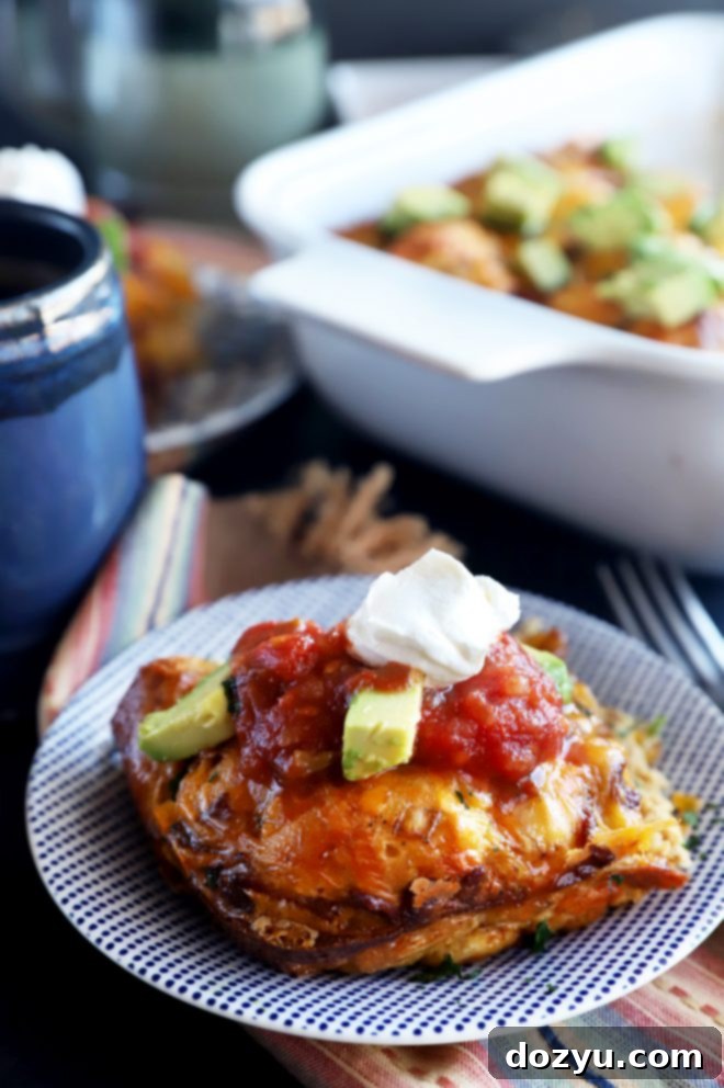 A close-up shot of a single slice of Mexican Bacon, Egg, and Cheese Biscuit Bake on a plate, showing its fluffy texture and golden-brown crust