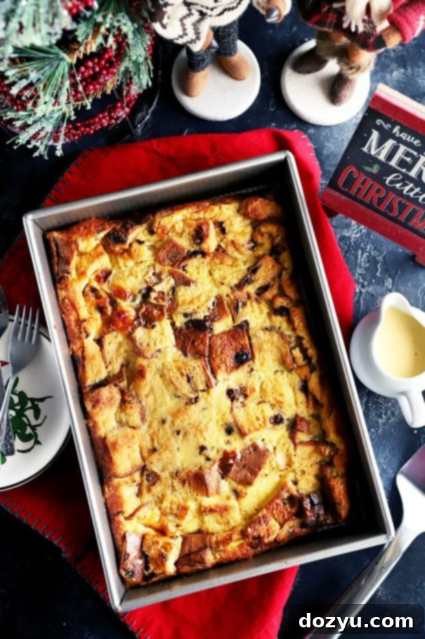 An overhead view of a large baking dish filled with golden-brown Panettone Bread Pudding, highlighting its inviting texture before serving.