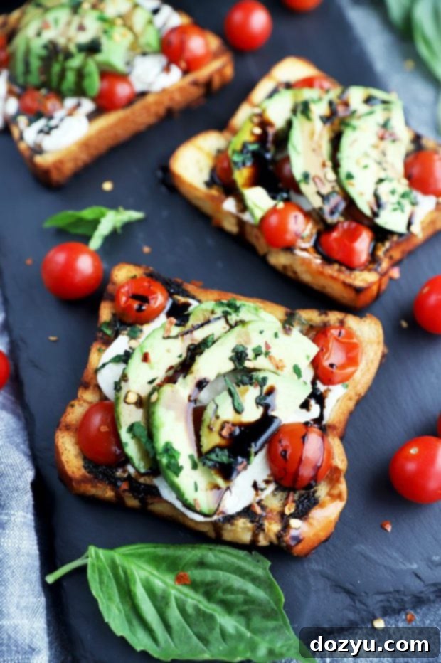 A perfectly grilled open-faced Caprese sandwich on a board, highlighting the rich colors and textures of the ingredients.
