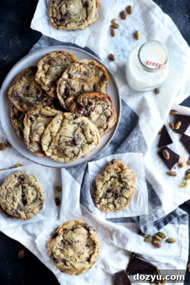 Overhead photo of dark chocolate pistachio cookies with milk, ready to be enjoyed