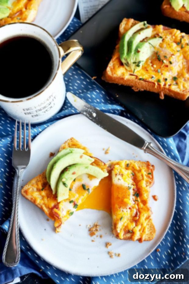 Overhead photo of cheesy egg in a hole with fresh avocado