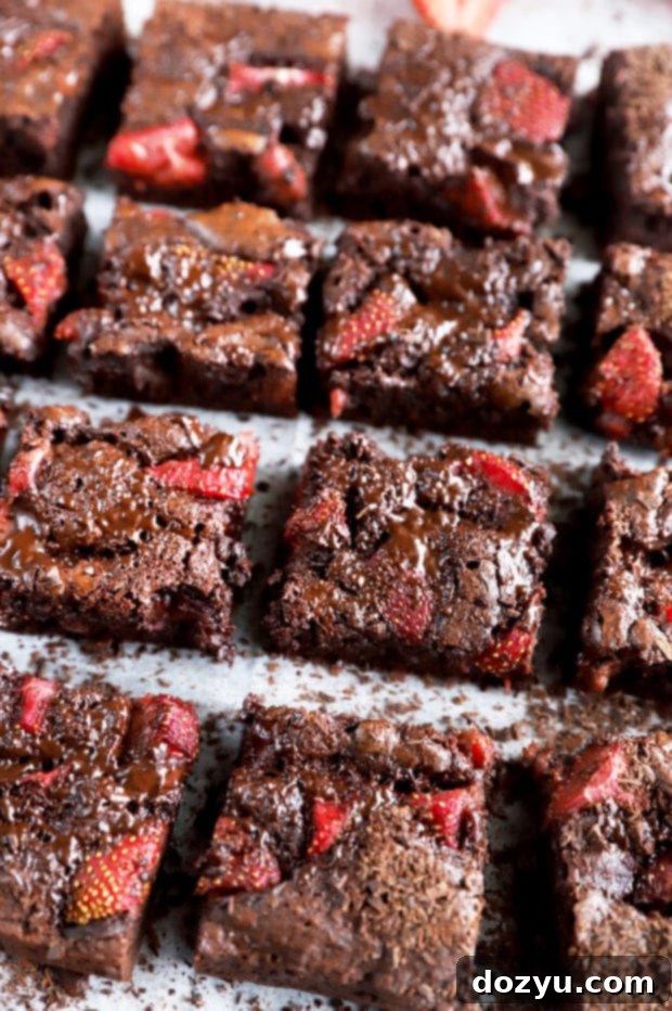Velvet Berry Chocolate Brownies 6 Chocolate brownies with strawberry picture, showcasing a slice on a white plate