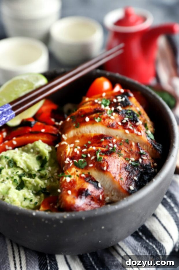 Close-up of grilled Korean chicken slices in a rice bowl