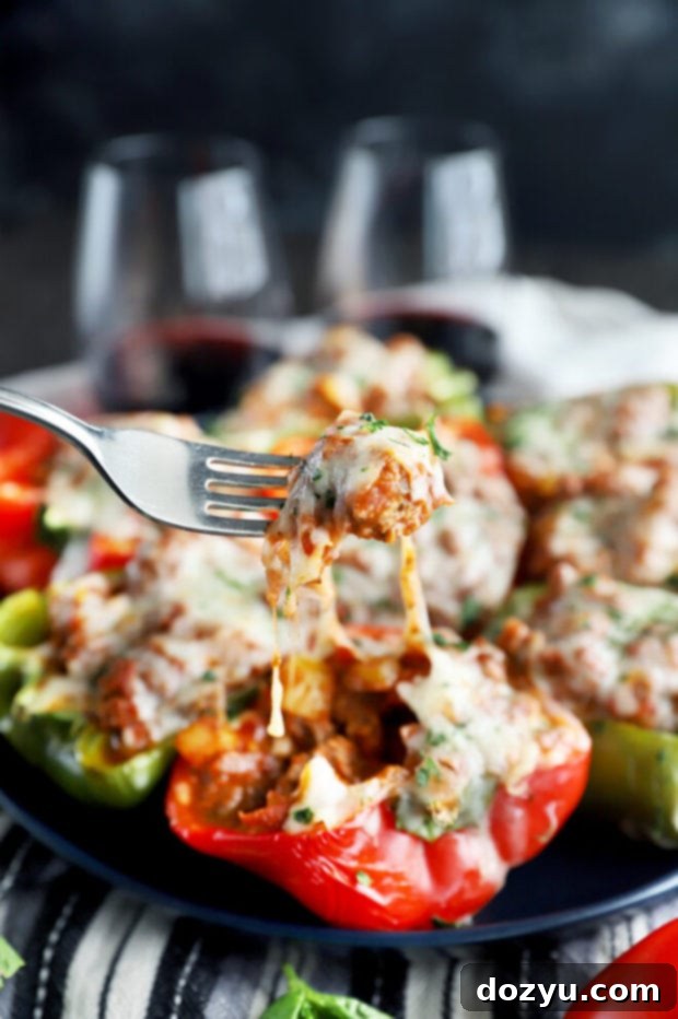 Bold Italian Stuffed Peppers 4 A close-up of a fork pulling cheesy filling from a Spicy Italian Stuffed Pepper