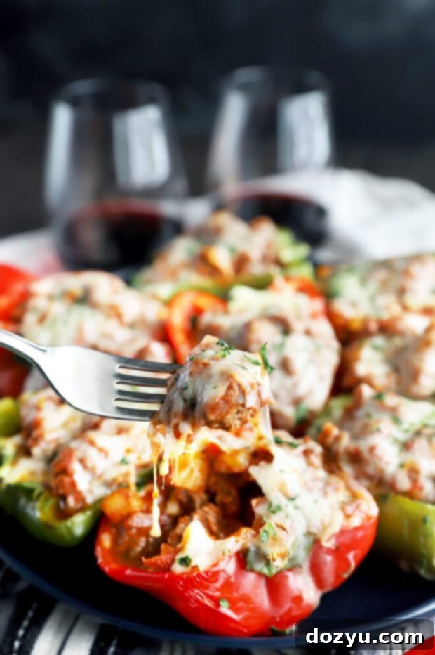 Bold Italian Stuffed Peppers 8 Forkful of cheesy, savory Spicy Italian Stuffed Pepper on a white plate