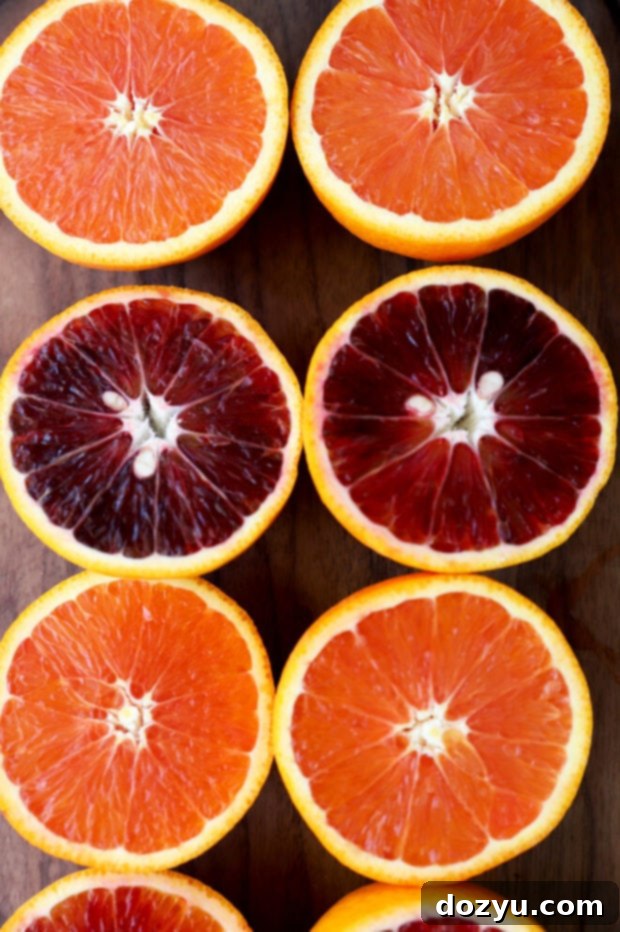 A close-up shot of Sunkist Blood Orange and Cara Cara Orange halves, revealing their distinctive internal colors and juicy segments, inviting you to explore their unique flavors.