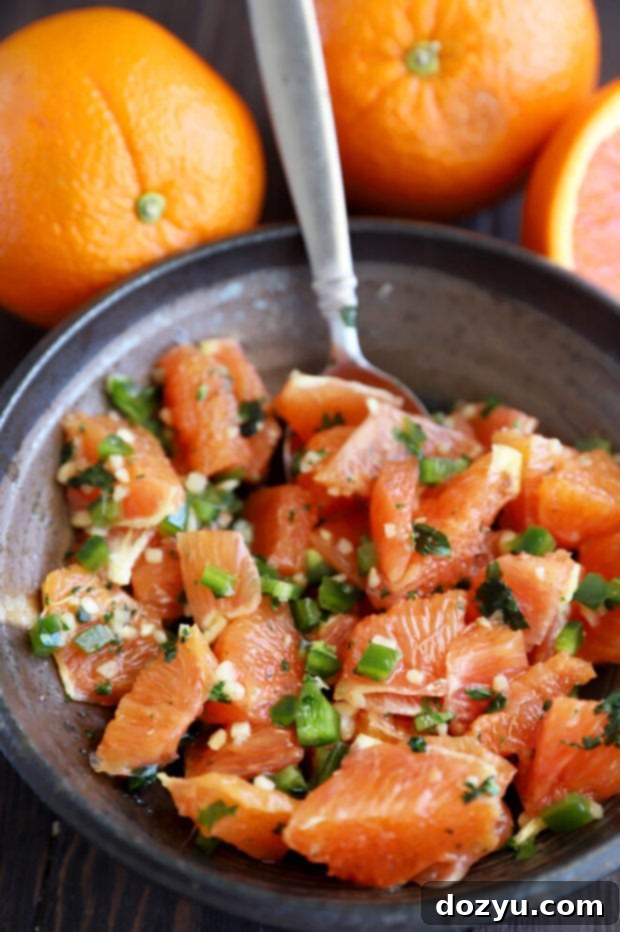 A bowl of freshly made Cara Cara Orange Salsa, featuring chopped Cara Cara oranges, cilantro, and diced jalapeño, highlighting its bright and zesty appearance.