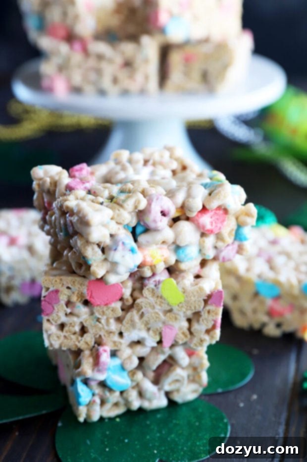 A large pile of freshly made Lucky Charms cereal treats, highlighting their abundant colorful marshmallows.