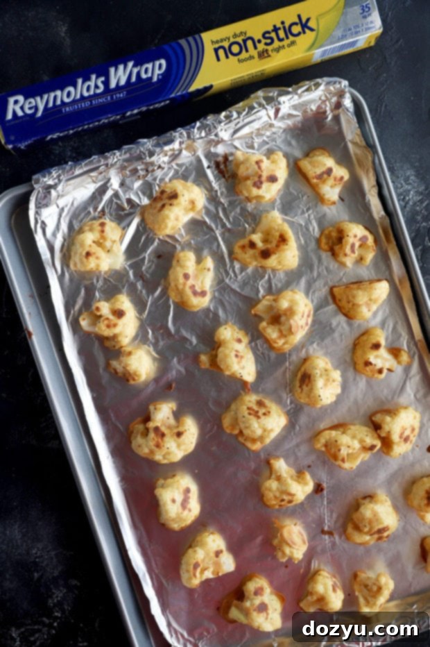 Overhead shot of baked cauliflower florets on a baking sheet