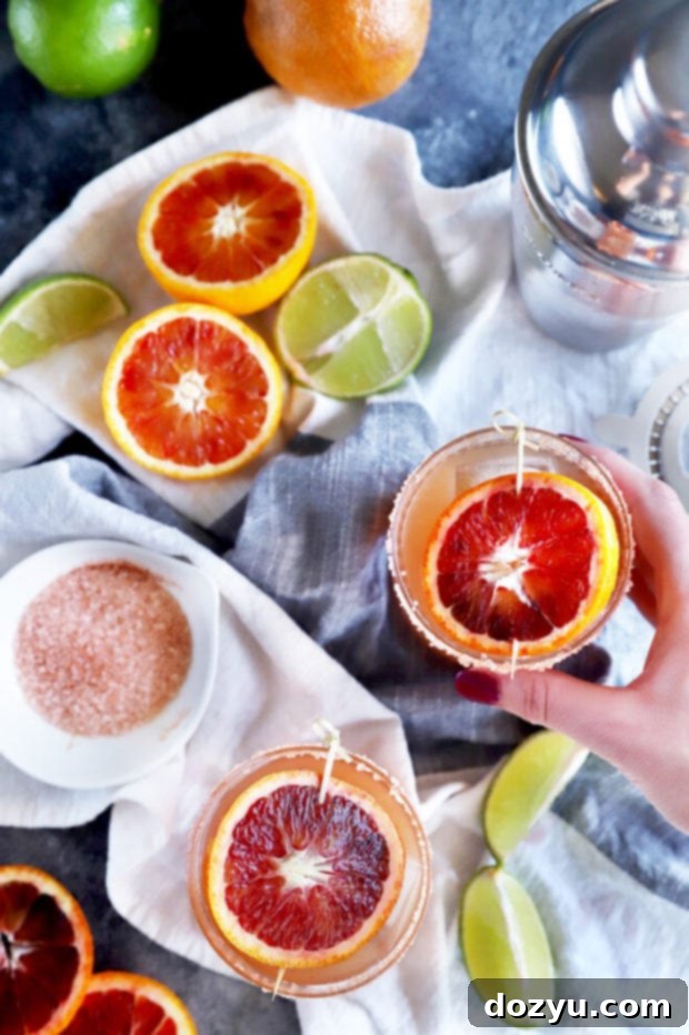 Hand holding a blood orange margarita photo