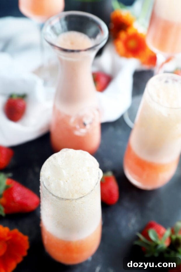 Strawberry Sparkler 4 Overhead view of several strawberry mimosas with fresh berry garnishes