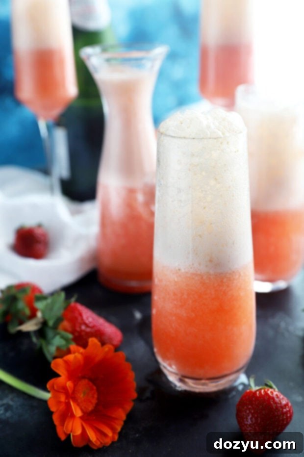 Strawberry Sparkler 5 Side view of a strawberry mimosa in a champagne flute, garnished with a strawberry slice