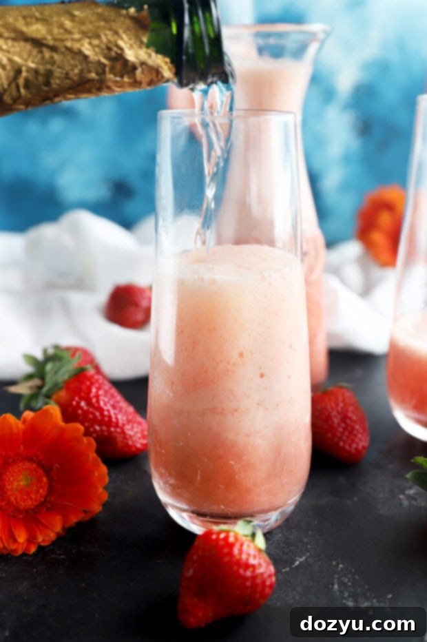 Strawberry Sparkler 7 Pouring champagne into a flute with strawberry-orange mixture for a mimosa