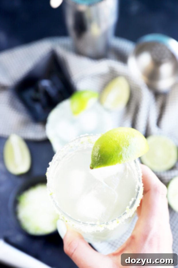 Hand holding a margarita photo