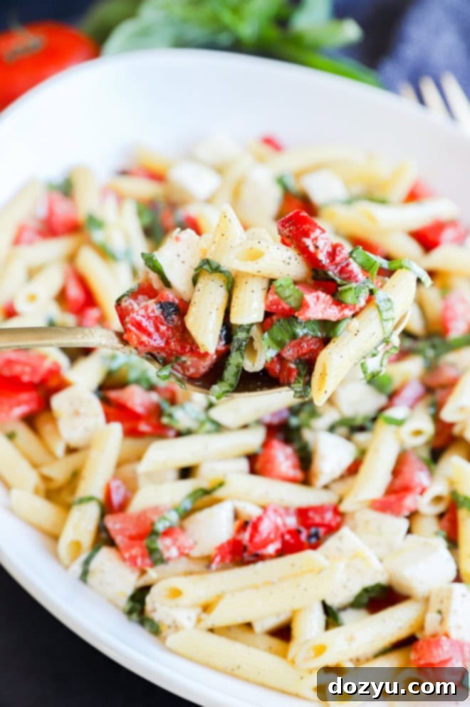 spoonful of summer lemon pasta salad with fresh basil and tomatoes