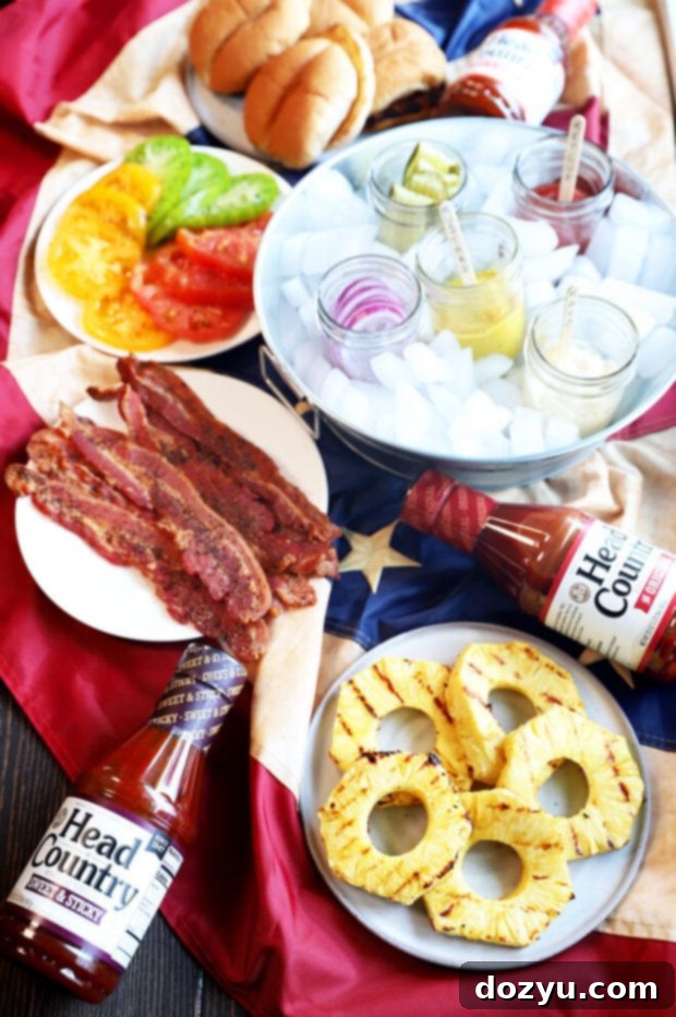 An elaborate overhead view of a fully assembled gourmet BBQ burger bar