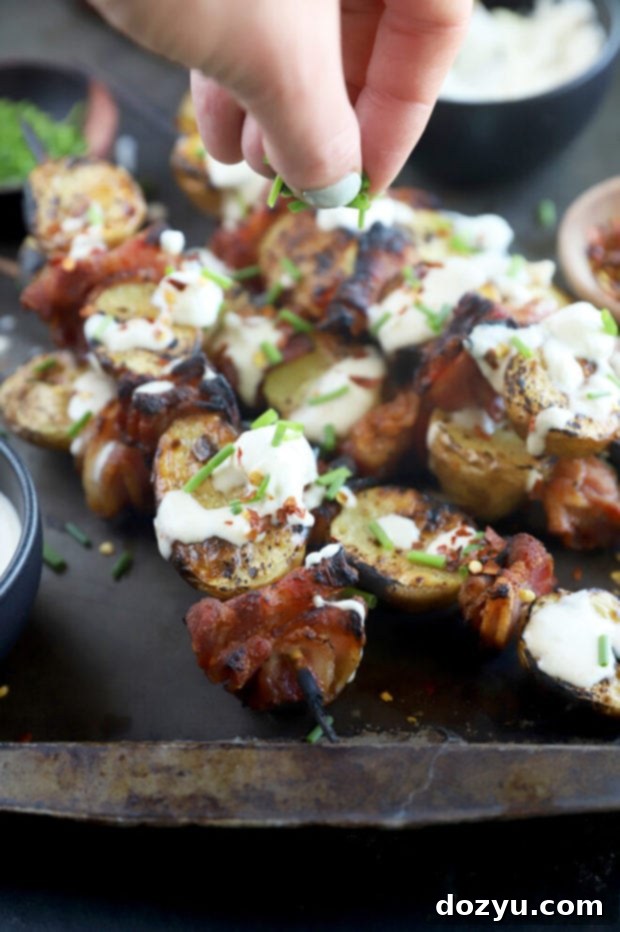 Cheesy Bacon Potato Skewers 4 Sprinkling chives on top of skewers image