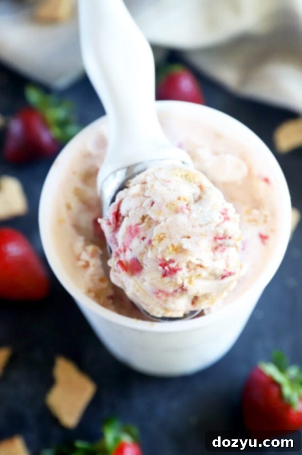 Freshly made strawberry compote simmering in a saucepan, showing the berries breaking down and the mixture thickening, releasing a sweet aroma.