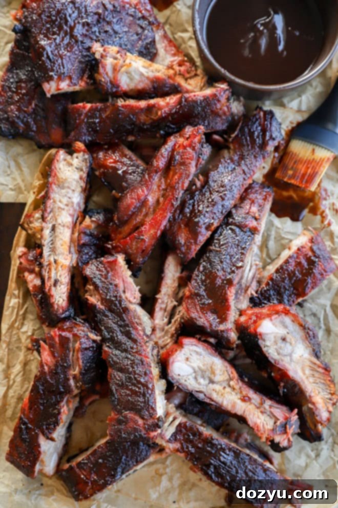 sliced pork BBQ on parchment paper on baking sheet