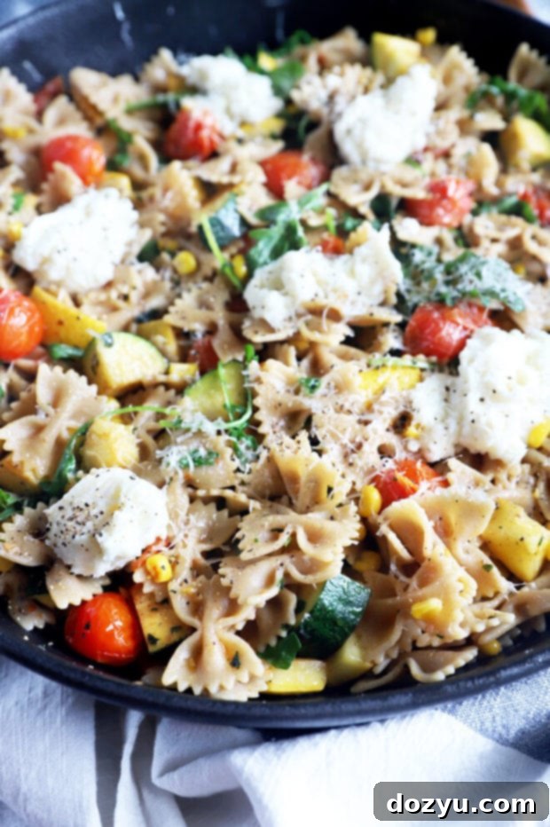A large serving bowl filled with vegetarian pasta, showcasing the vibrant mix of vegetables and a light sauce.
