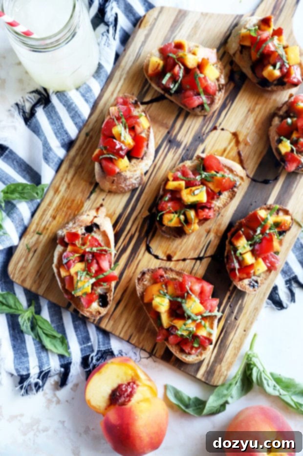 Overhead shot of a colorful summer appetizer, highlighting the fresh peach and tomato mixture.