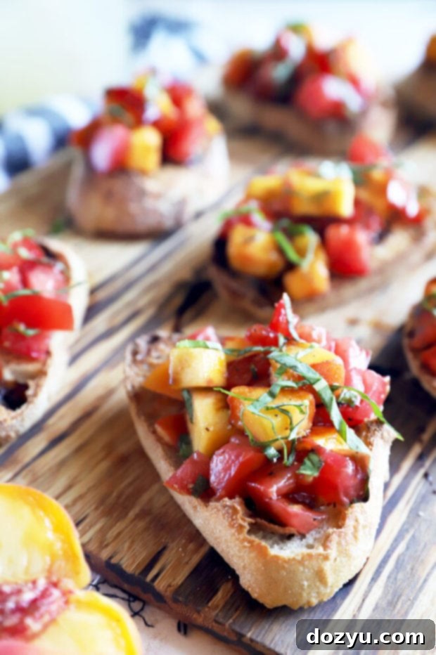 Close-up of tomato bruschetta on toasted bread, garnished with fresh basil.