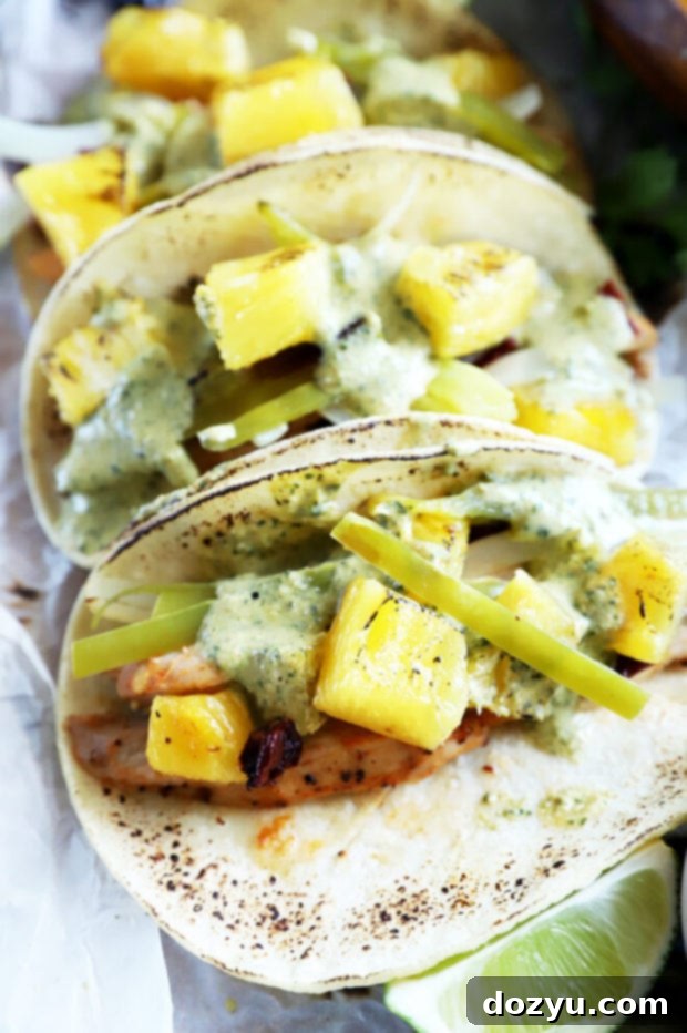 Close-up shot of grilled chipotle chicken tacos with fresh toppings.