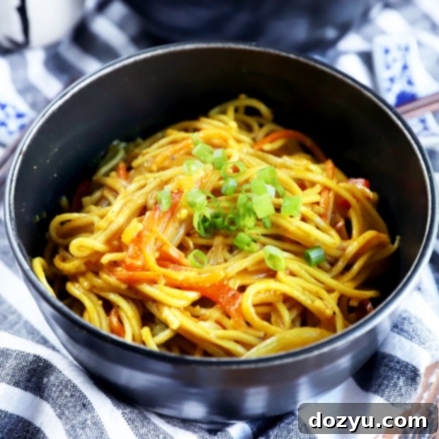 Top-down view of a serving of Singapore Street Noodles with chopsticks