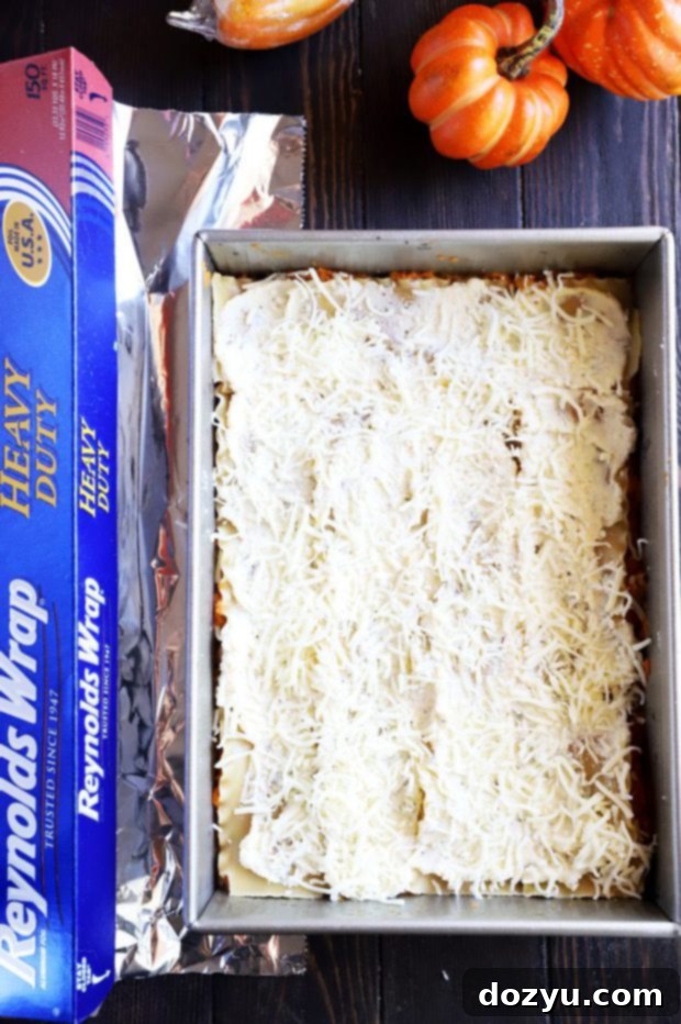 A baker preparing the pumpkin lasagna, using Reynolds Wrap foil on a baking sheet