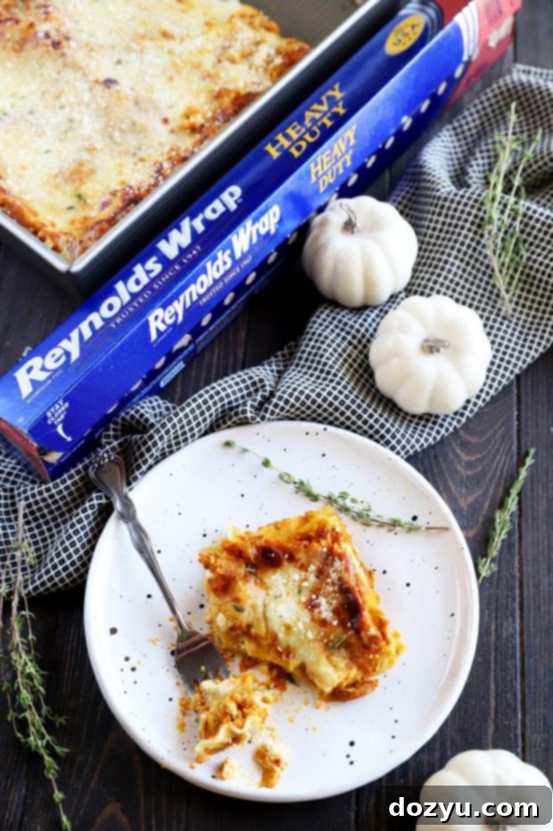 Overhead photo showing a full pan of lasagna next to a roll of Reynolds Wrap foil