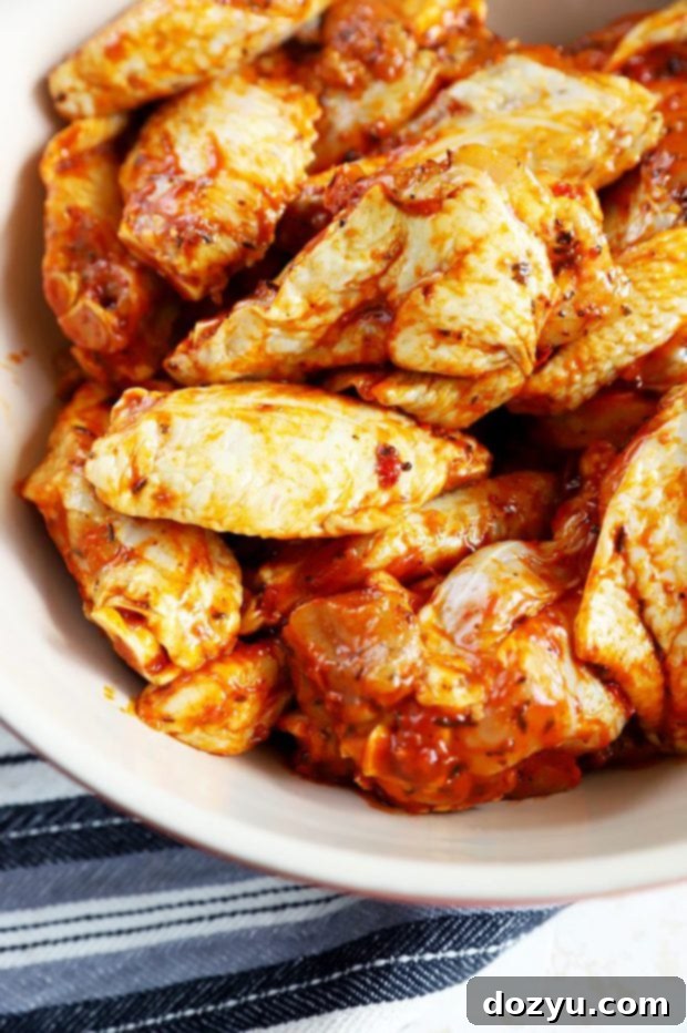 Bowl of succulent Sprouts Island Jerk Wings, showcasing their rich marinade and delicious appearance