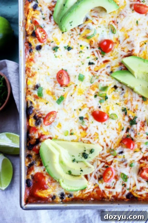 Overhead photo of a bubbling pumpkin enchilada bake, fresh from the oven