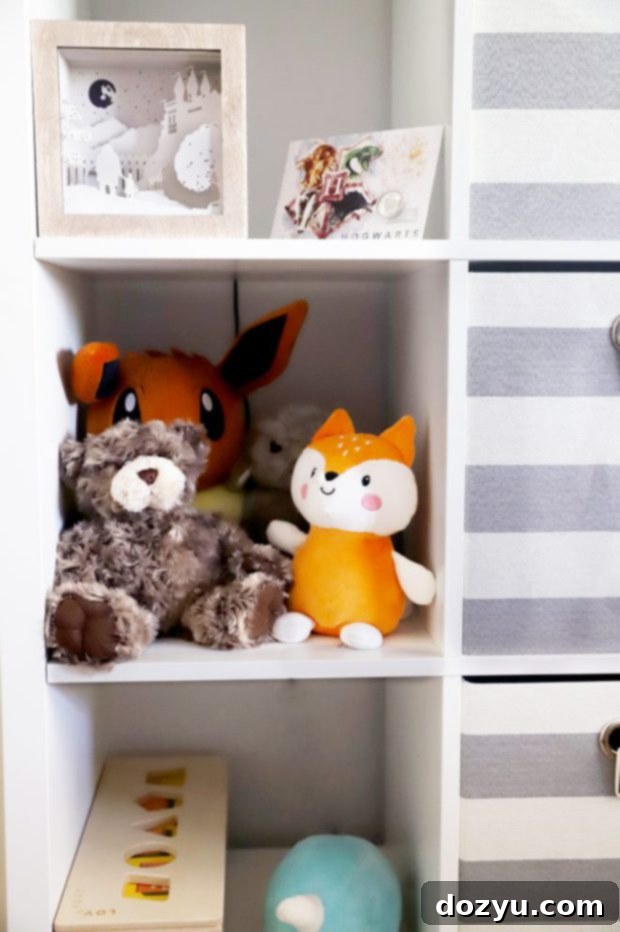 A cozy corner of the Harry Potter nursery with a comfortable recliner, side table, and humidifier.