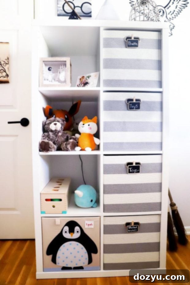 Organized nursery shelves featuring striped storage bins with chalkboard labels and Harry Potter decor.