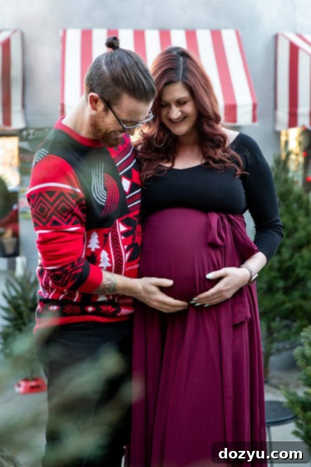 Denver Maternity photo featuring an expecting couple among Christmas trees