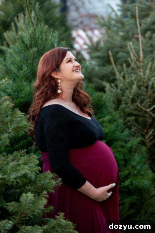 Maternity image with Christmas tree farm backdrop, showcasing the beauty of the season