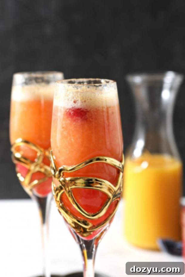 Brunch Bliss Raspberry Mimosa 2 Side photo of a perfectly poured raspberry mimosa in a flute